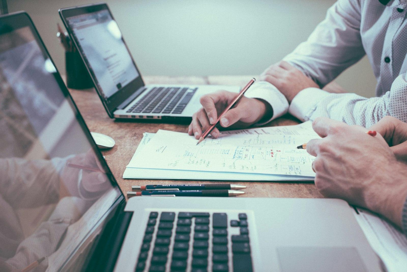 An accountant reviewing financial documents with a client at a desk